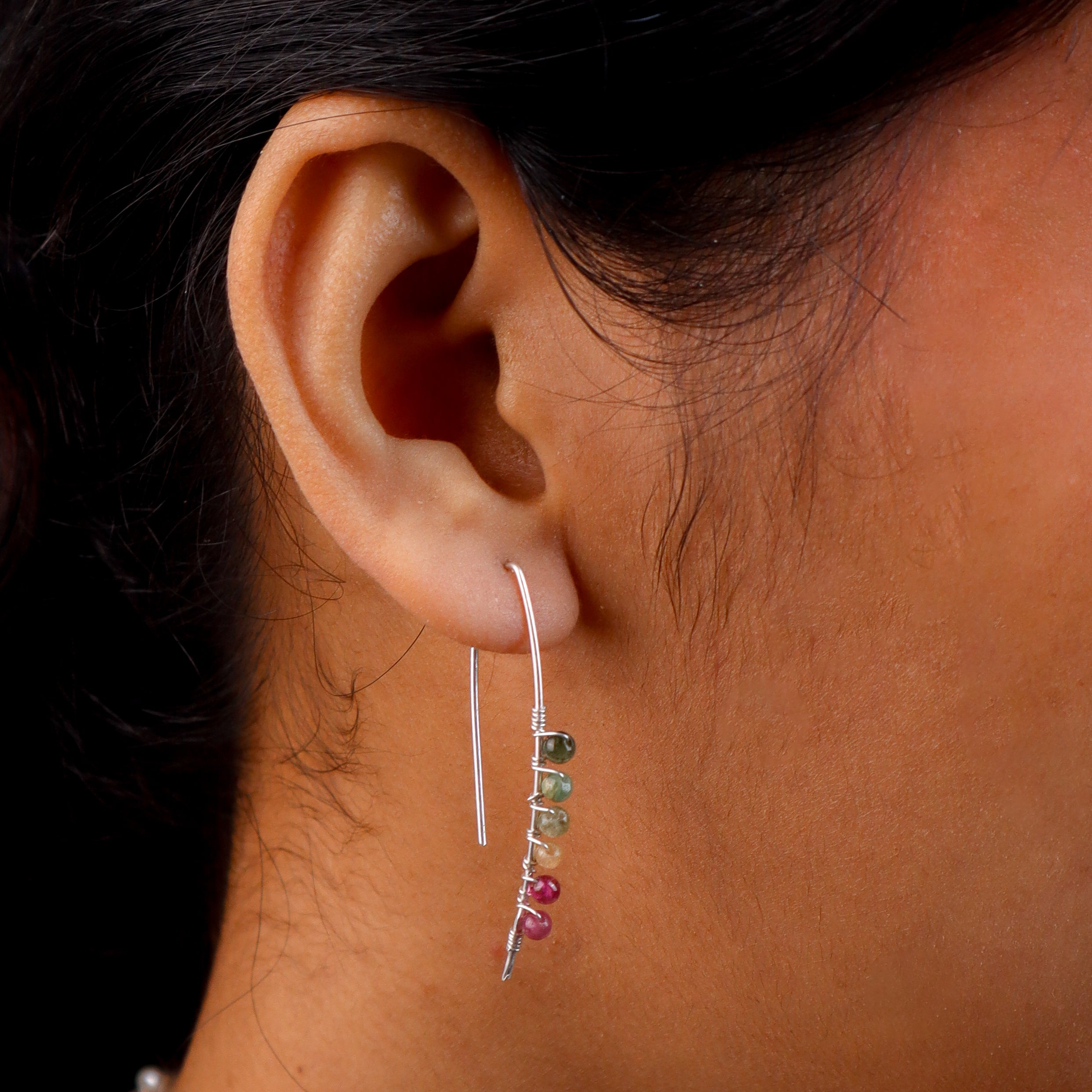 Woman wearing silver multicolour stone earrings