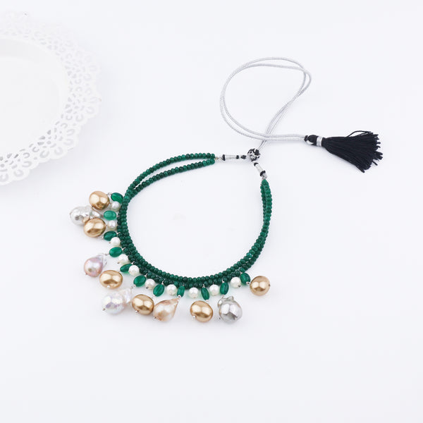 Model wearing green onyx and pearl necklace with black tassel for jewelry accessories
