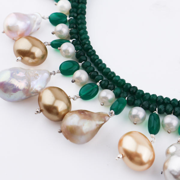 Detailed view of green onyx, pearls, and baroque pearls on the necklace