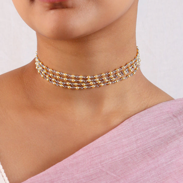 Close-up of golden pearl choker highlighting lustrous pearls and 22K gold plated detailing