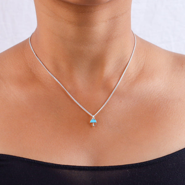 Silver umbrella pendant necklace on neck