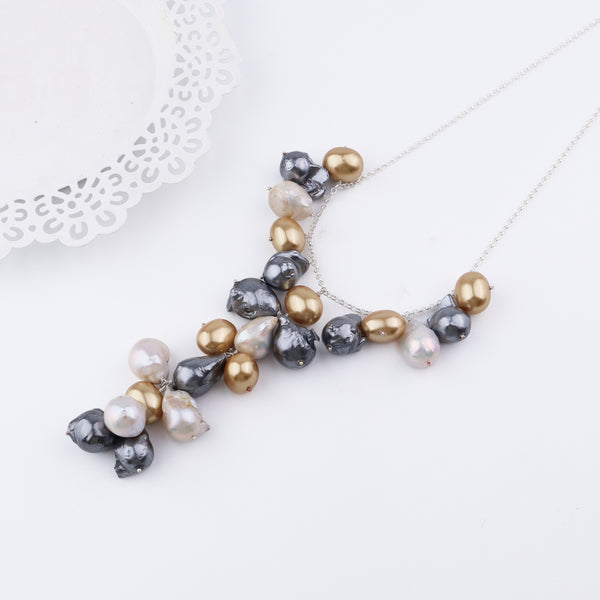 Close-up of multicolored baroque pearl necklace on white background