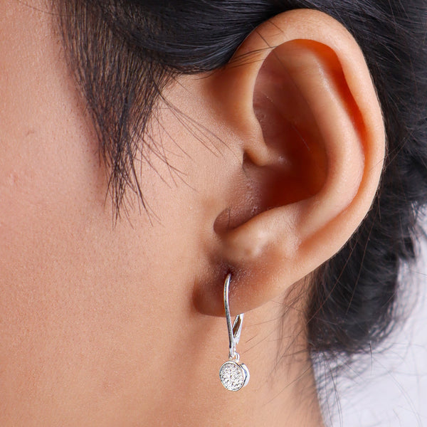 Close-up of woman's ear with silver earring