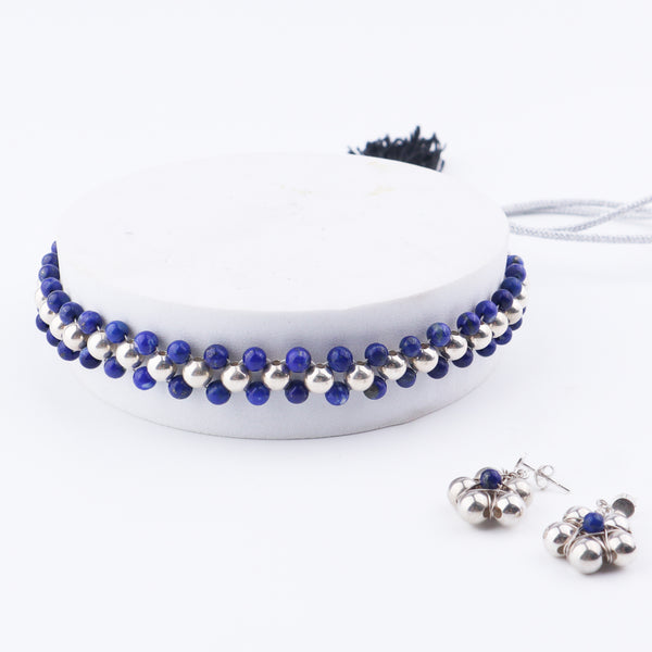 Detail shot of silver bead thushi pattern and lapis accents