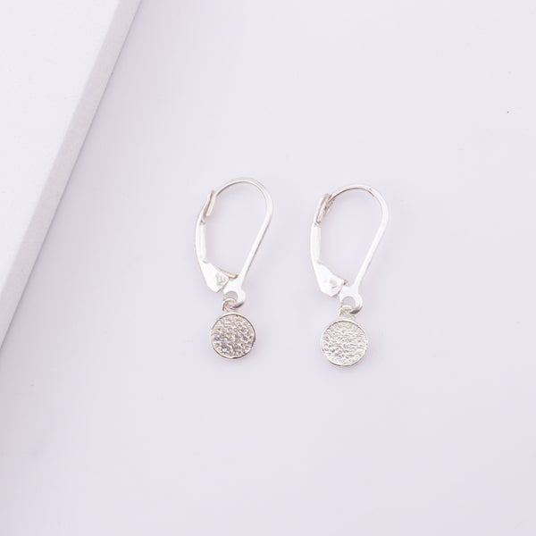 Woman wearing silver Druzy earrings