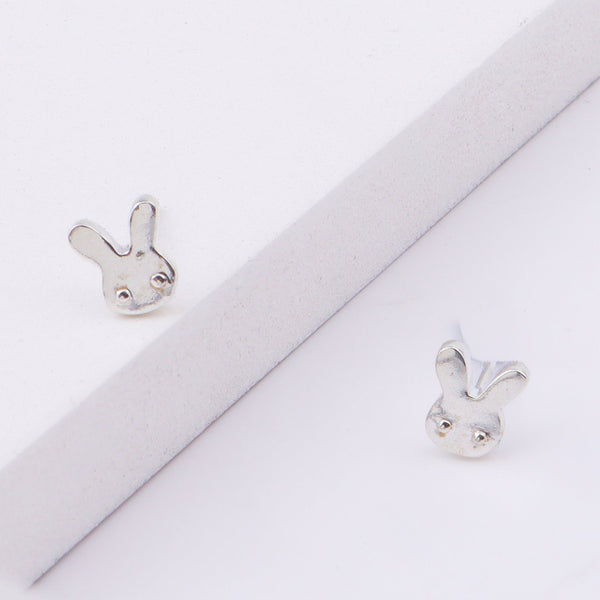 Close-up of bunny stud earrings on ear