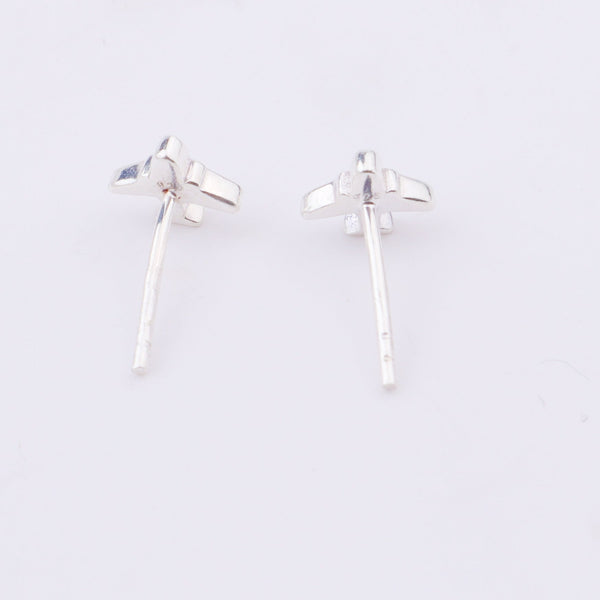 Silver airplane earrings on white display with close-up
