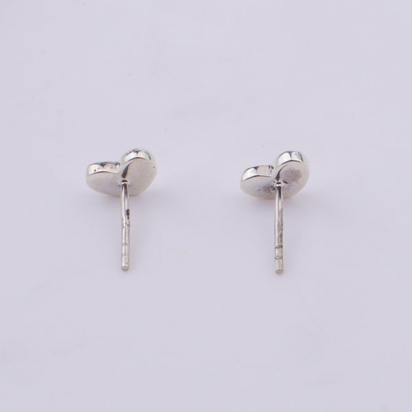 Silver heart stud earrings on white background