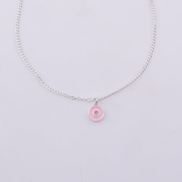 Close-up of silver chain with pink enamel donut pendant