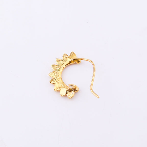 Gold-plated floral nose ring on white background