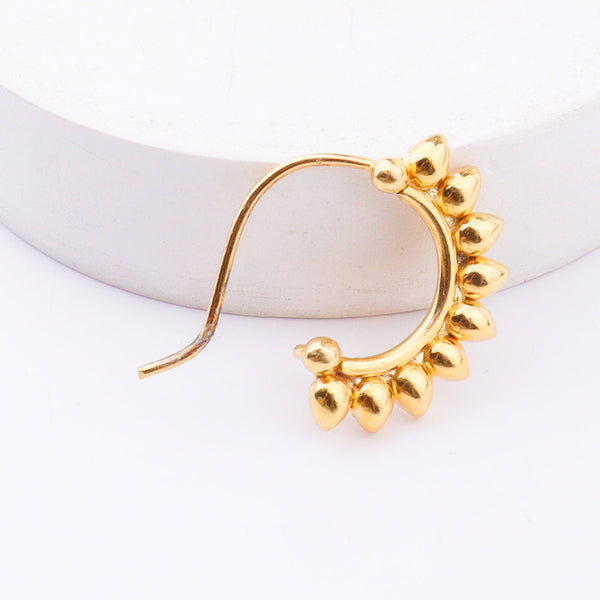 Elegant gold floral nose ring on model