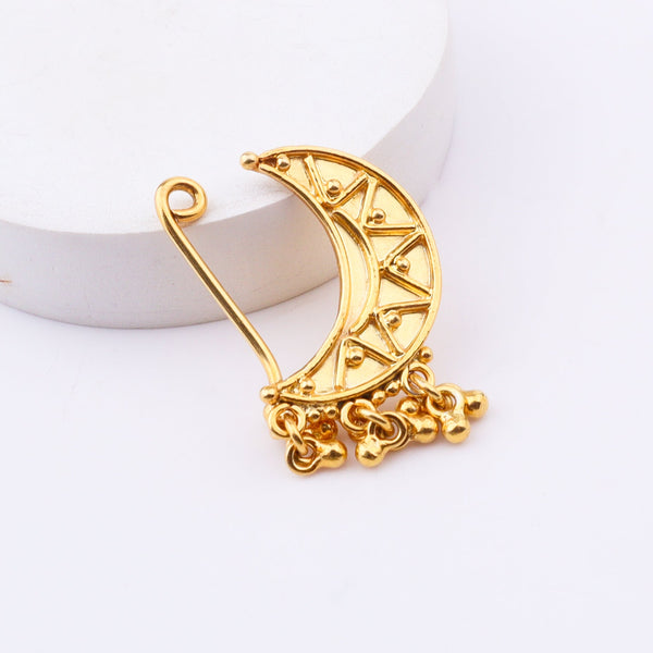 Gold crescent moon earring on white background