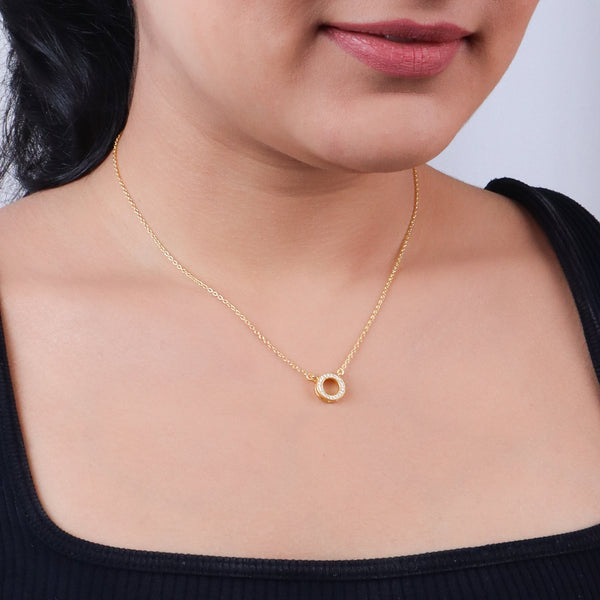 Gold circle CZ pendant necklace on woman's neck