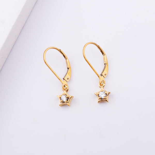 Gold star earrings with cubic zirconia stones on white background