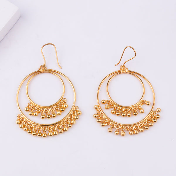 Gold earrings on white background