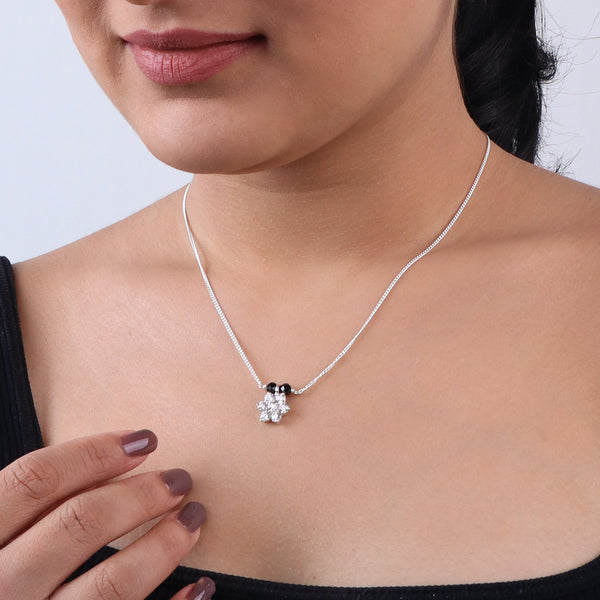 Elegant silver necklace with floral pendant and black stones