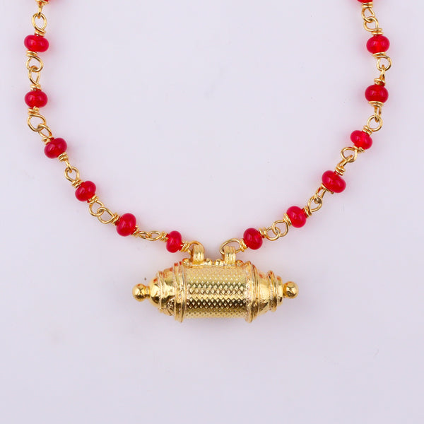 Elegant gold necklace with red beads and pendant