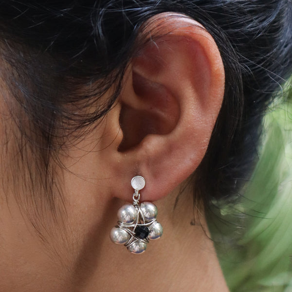Angled view of Silver Bead Thushi Set with Black Spinel