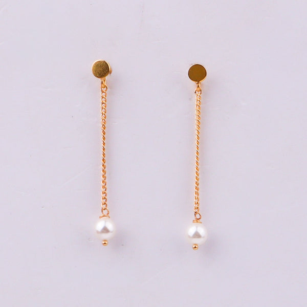 Gold chain earrings with pearl drops on white background