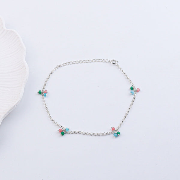 Silver anklet with beads on white background