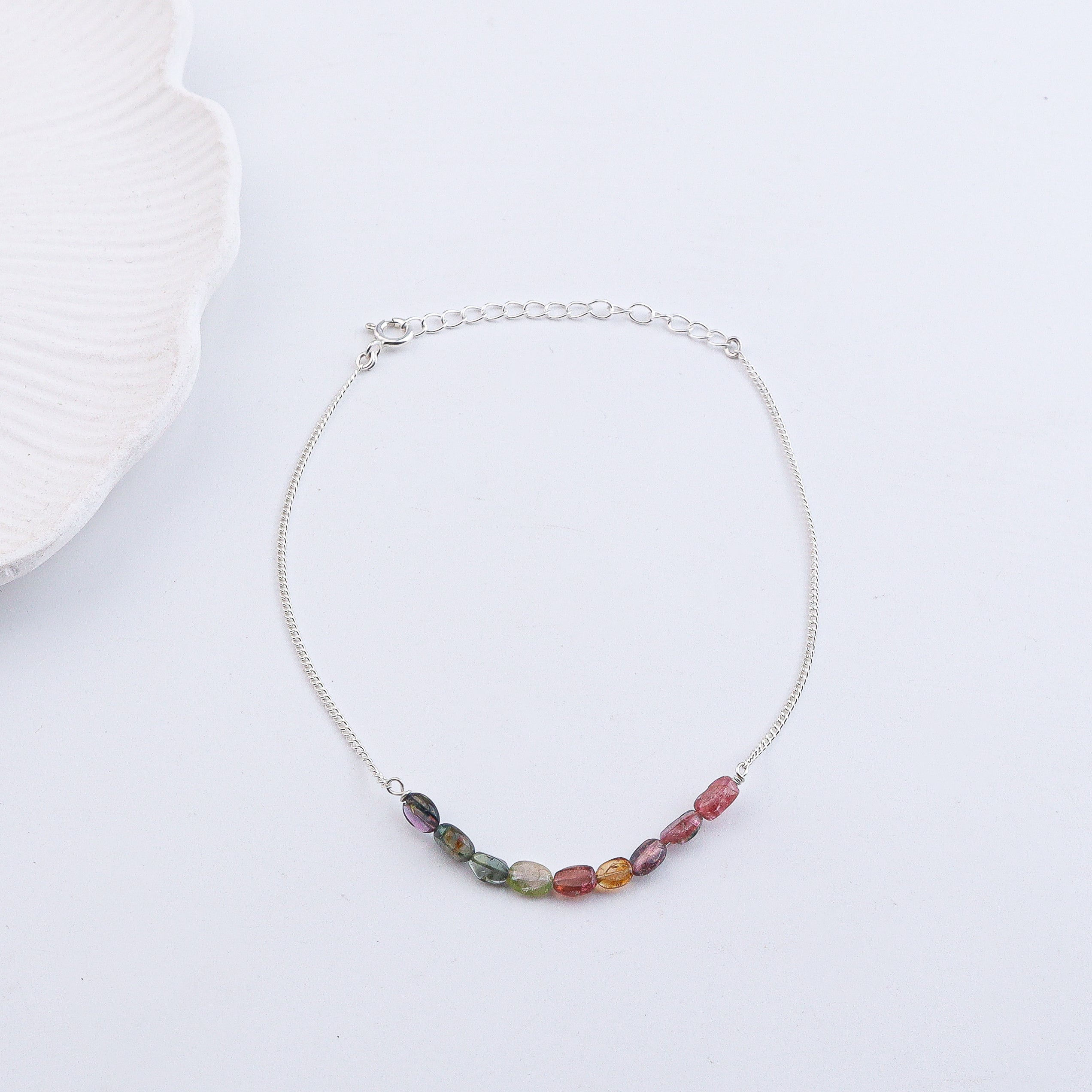 Colorful beaded anklet on wrist