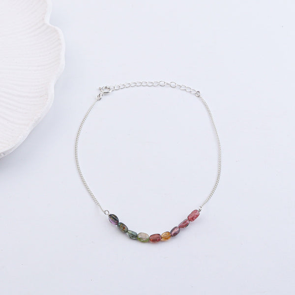 Colorful beaded anklet on wrist