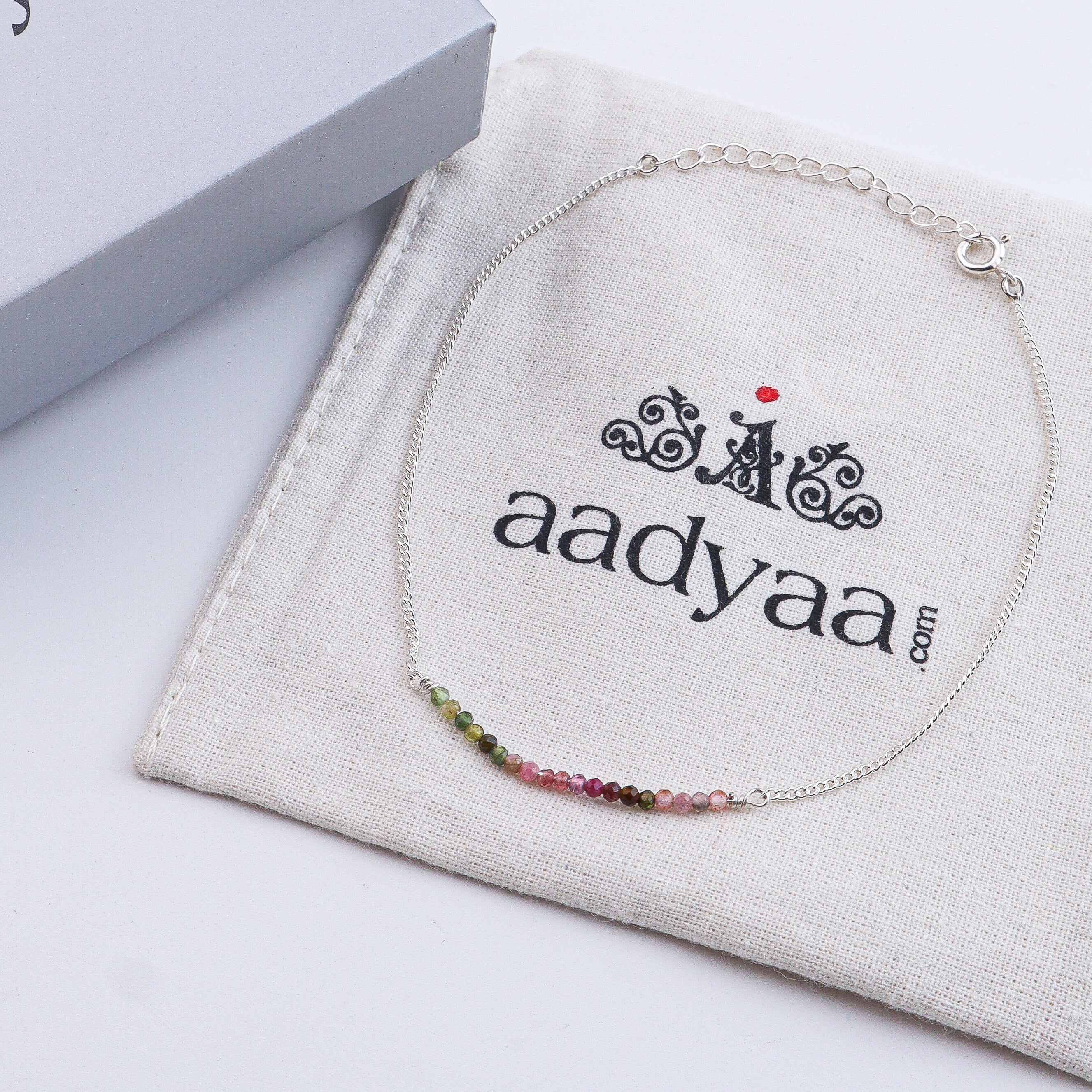 Close-up of silver anklet with colorful beads