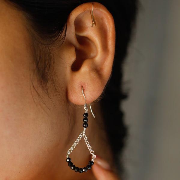 Black spinel silver chain earrings close-up detailing