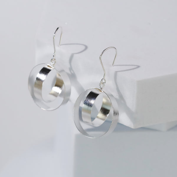 close-up of silver hoop earrings on display
