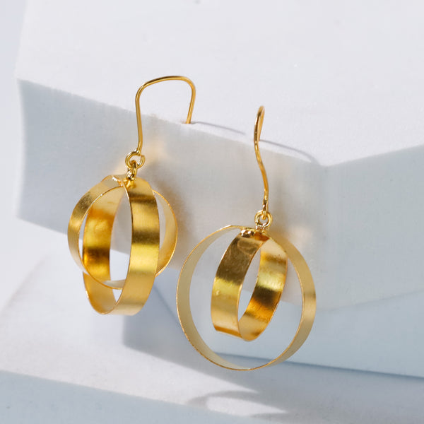 Close-up of gold earrings on a white background