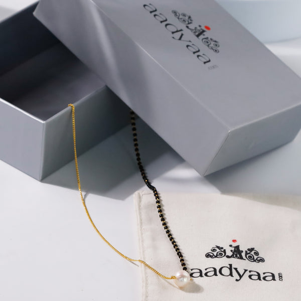 Gold and black pearl necklace in box