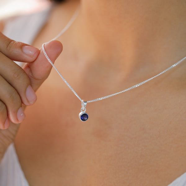 Silver necklace with blue gemstone pendant