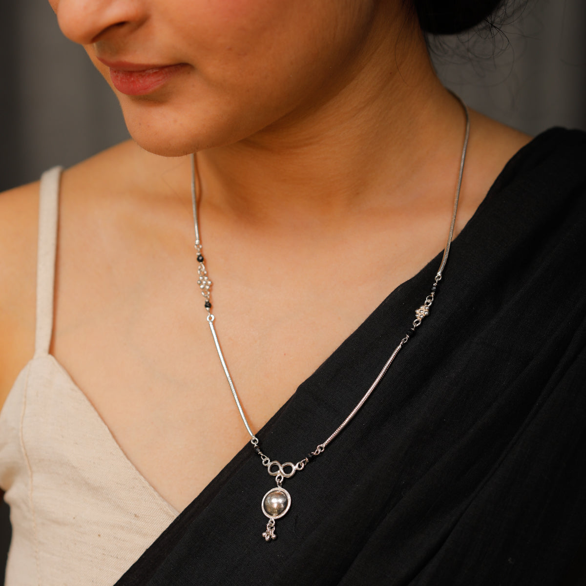 Silver mangalsutra with kudi and infinity motif