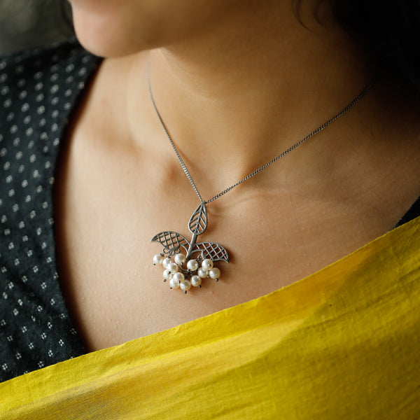 leaf filigree detailing on oxidized silver necklace