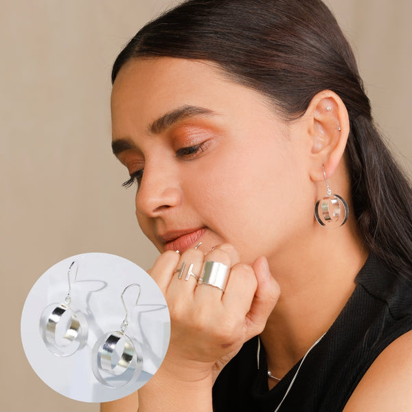 woman wearing shiny silver hoop earrings