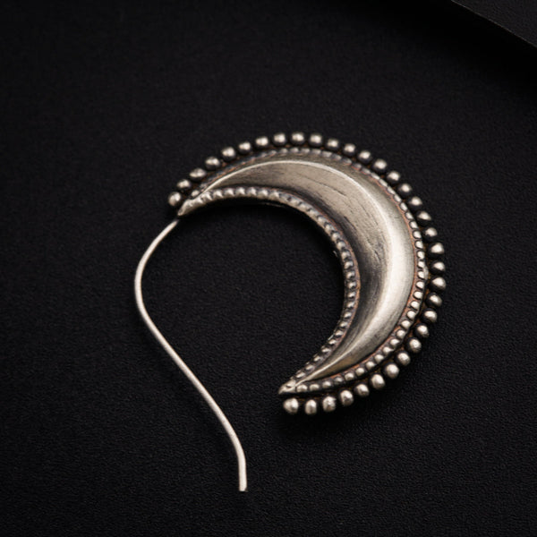 a close up of a metal object on a black surface