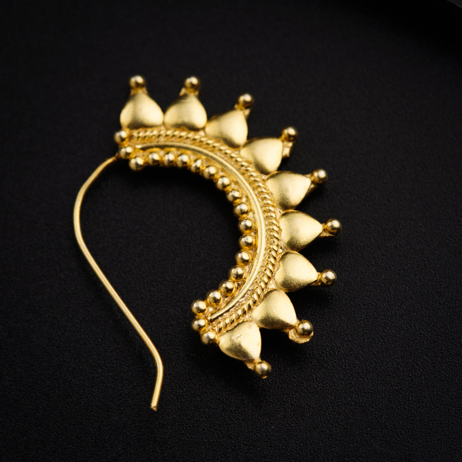 a close up of a piece of jewelry on a black surface
