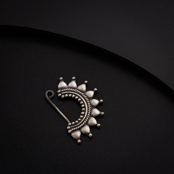 a close up of a metal object on a black surface