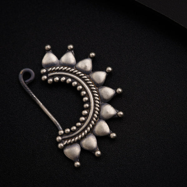 a close up of a metal object on a black surface