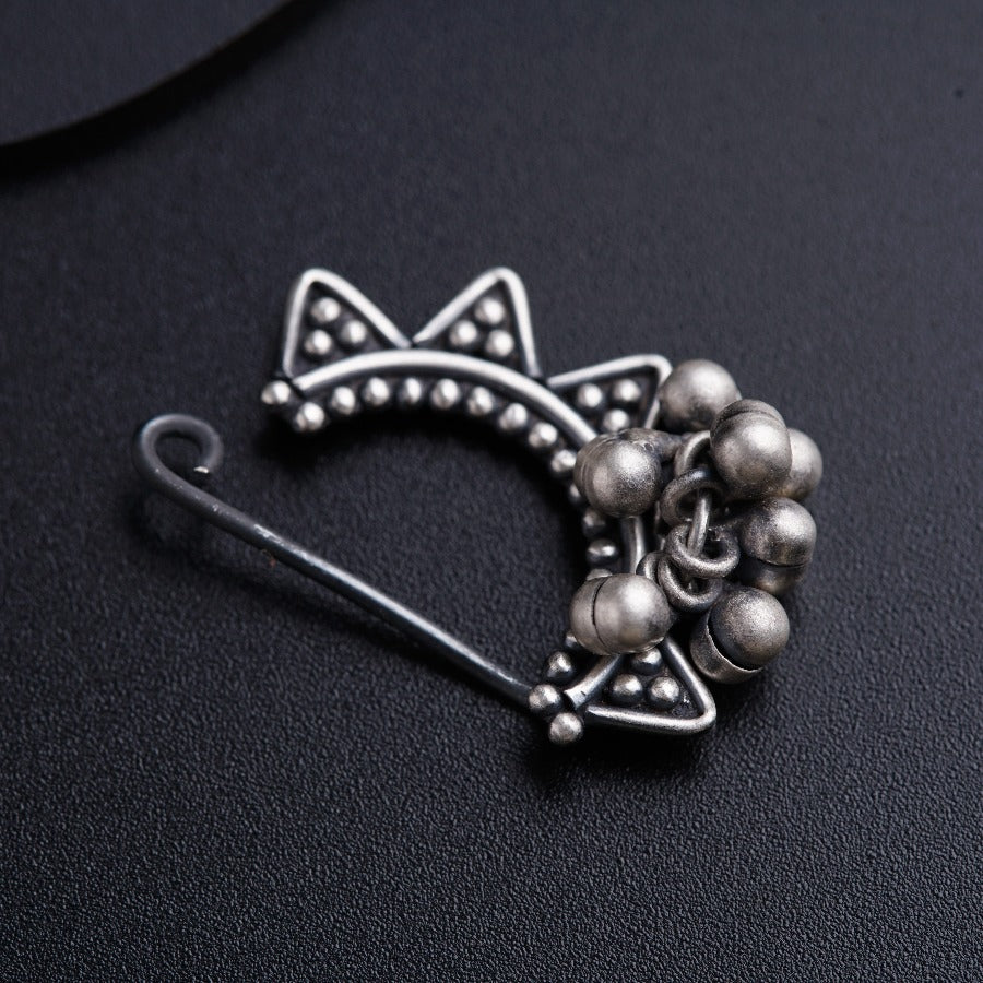 a silver brooch with a cat design on it