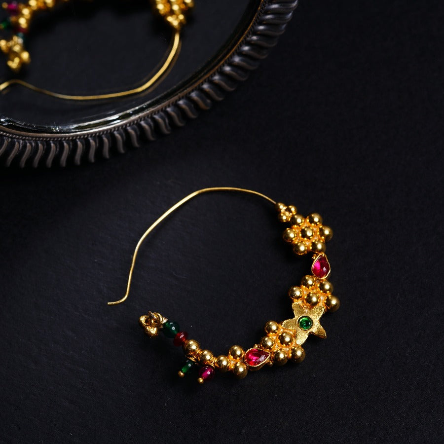 a pair of gold - plated hoop earrings with multi - colored stones
