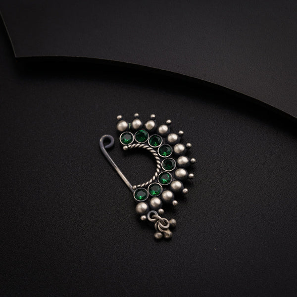 a close up of a brooch on a black surface