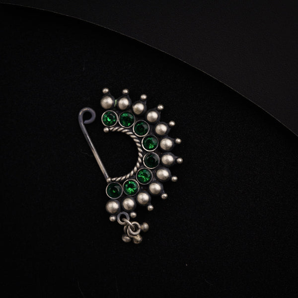 a close up of a brooch on a black surface