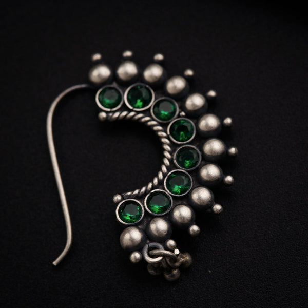 a close up of a brooch on a black surface