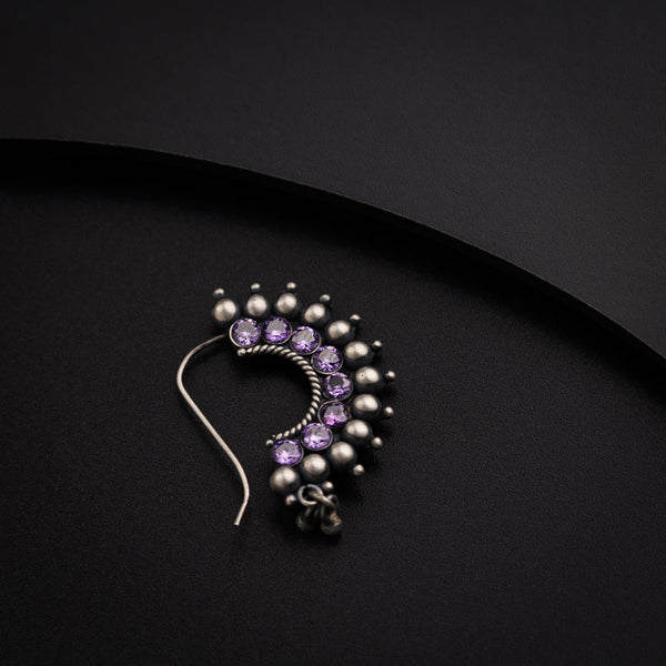 a close up of a pair of earrings on a black surface