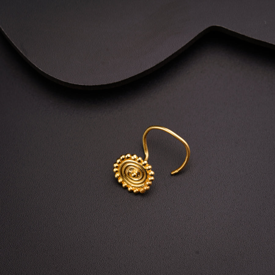 a close up of a pair of earrings on a black surface