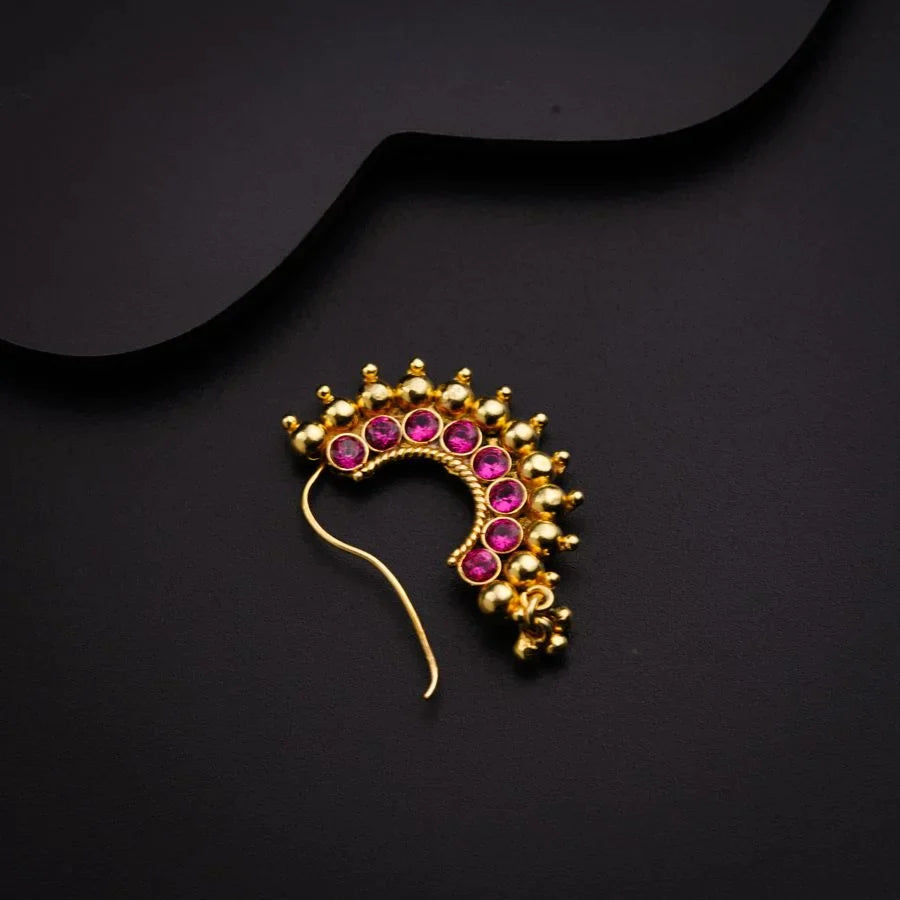 a pair of gold and pink stoned hair clips