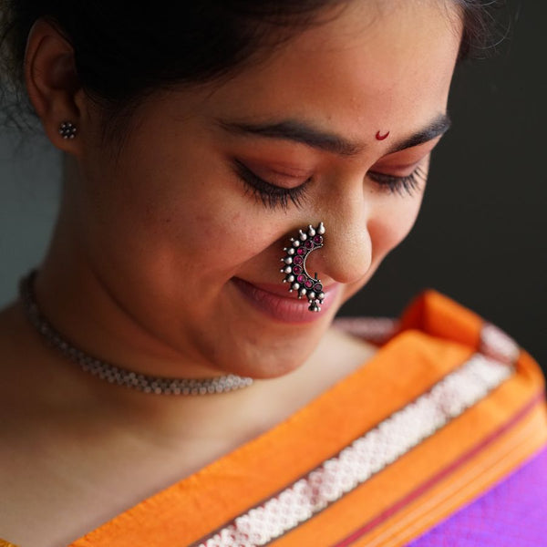 a woman with a nose ring and nose piercing