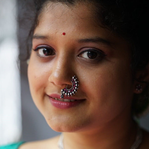 a close up of a woman with a nose ring