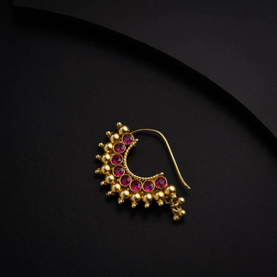 a pair of gold earrings with pink stones